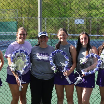 Six seniors on the girls tennis team pose for a photo with their coach during Senior Night.