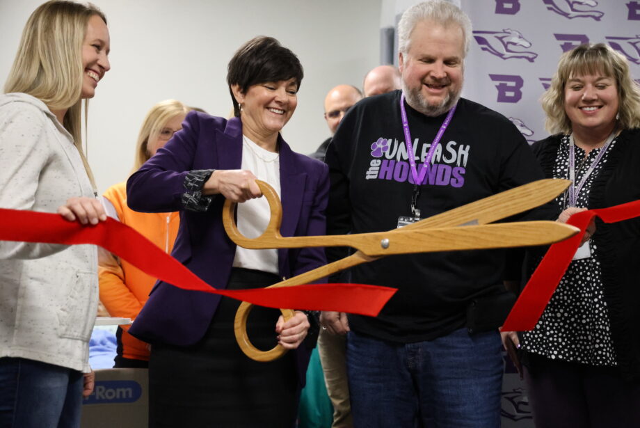 Burlington School Board members Christi Burghoffer, Darven Kendell and Anika McVay hold a ribbon being cut by Burlington High School Principal Monica Myers Monday, Feb. 19, in the health occupations lab at BHS.