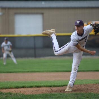 A pitcher throws a pitch during a baseball game.