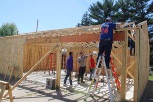 Construction Trades students build a garage under the supervision of their teacher. 