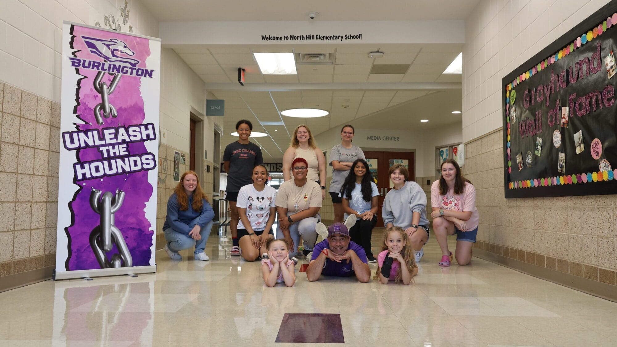 Instructional coach and summer school coordinator Michael Carper poses for a photo alongside elementary students and high school helpers Aug. 1, 2024, at North Hill Elementary School.  