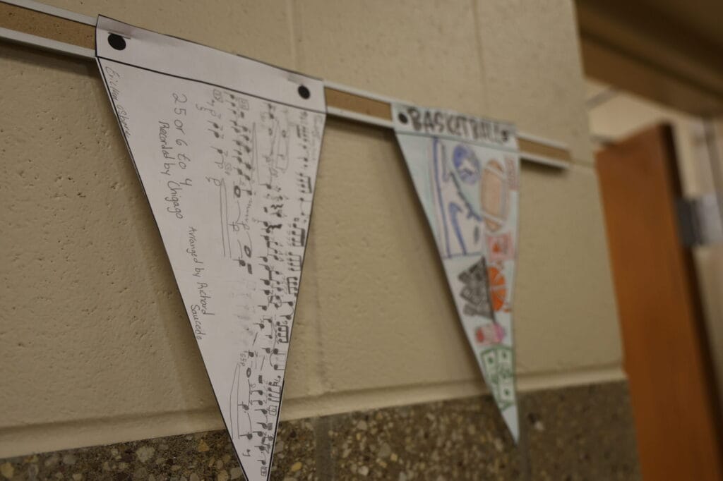 Student Ericka Osborn's first place-winning entry in black and white Pennant Design is shown. She wrote out the sheet music for one of her favorite songs, “25 Or 6 To 4” by Chicago, on her pennant.