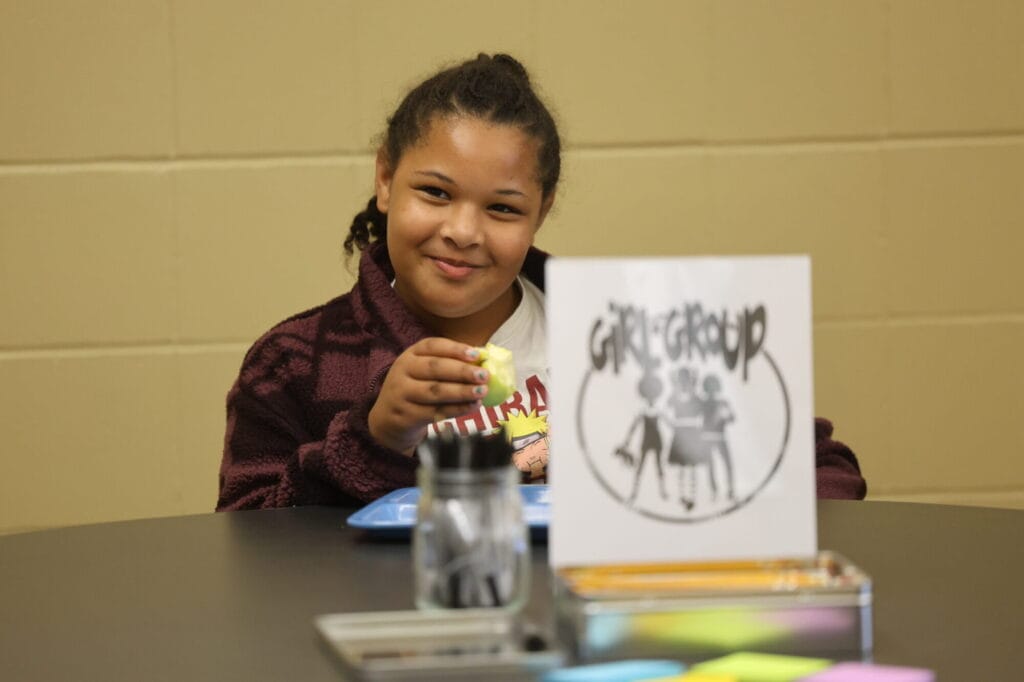 Fifth-grader Arrielle Enhorning smiles while eating her lunch after participating in an ice-breaker activity Sept. 19, 2024, during  Girls Group in Cree Webb’s office at Aldo Leopold Intermediate School. 