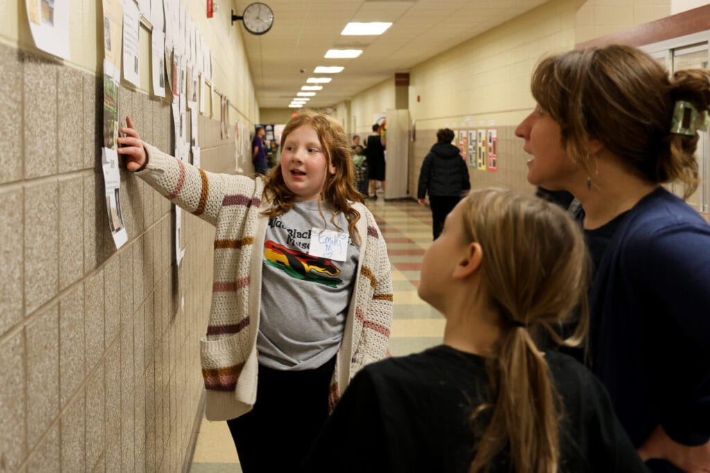 Fifth-grader Emily Mumm shows visitors a timeline Thursday, Feb. 27, 2025, during Aldo Leopold Intermediate School’s fourth annual Black History Museum.