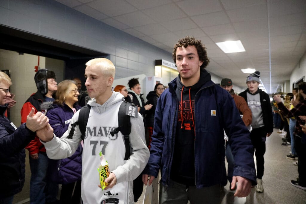 State wrestling qualifiers Adrian Perez-Hall and Braxton Hutchinson make their way through a student tunnel Feb. 18 following their send-off assembly at Burlington High School. Hutchinson went on to place 4th in his weight class.