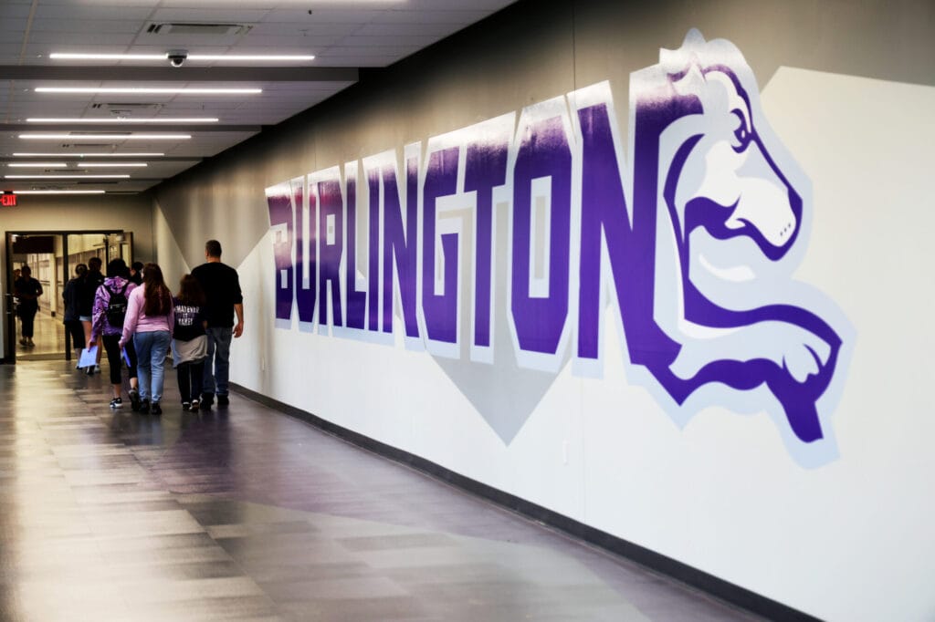 Visitors make their way down the connecting walkway between Burlington High School’s main and Industrial Arts buildings.