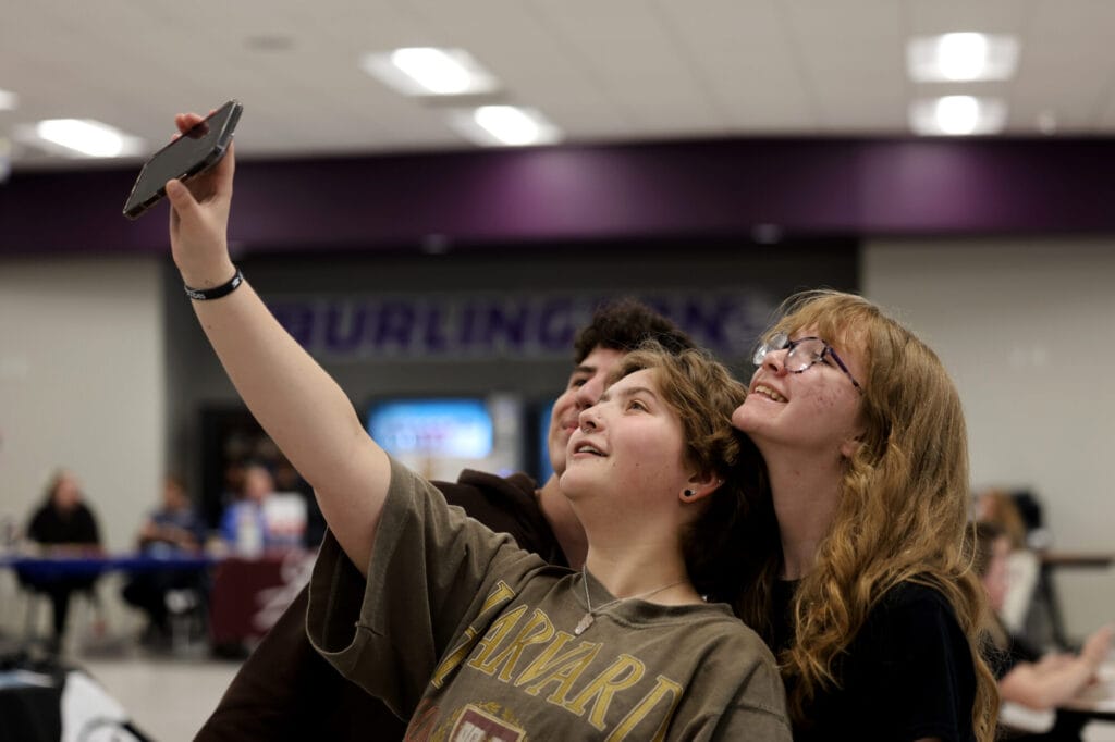 A trio of Burlington High School students pose for a cellphone selfie Tuesday, April 22, 2025, in the school cafeteria during an open house showcasing BHS's nearly complete $43 million renovation project.