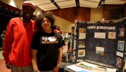 Demond Carr and his daughter, fifth-grader Journey Carr, pose for a photo alongside an exhibit about Louis Armstrong Thursday, Feb. 17, 2025, during Aldo Leopold Intermediate School’s fourth annual Black History Museum. The exhibit was one of more than 20 student-led projects on display.