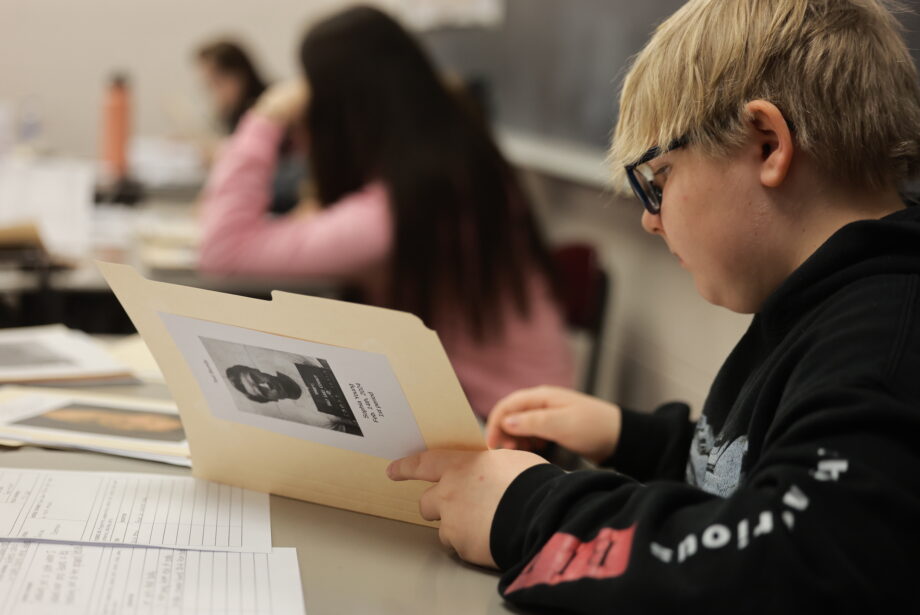 A student reviews a criminal profile while working to match it to a corresponding crime Feb. 15, 2024, in their American Justice, Crime and Punishment class at Burlington High School.