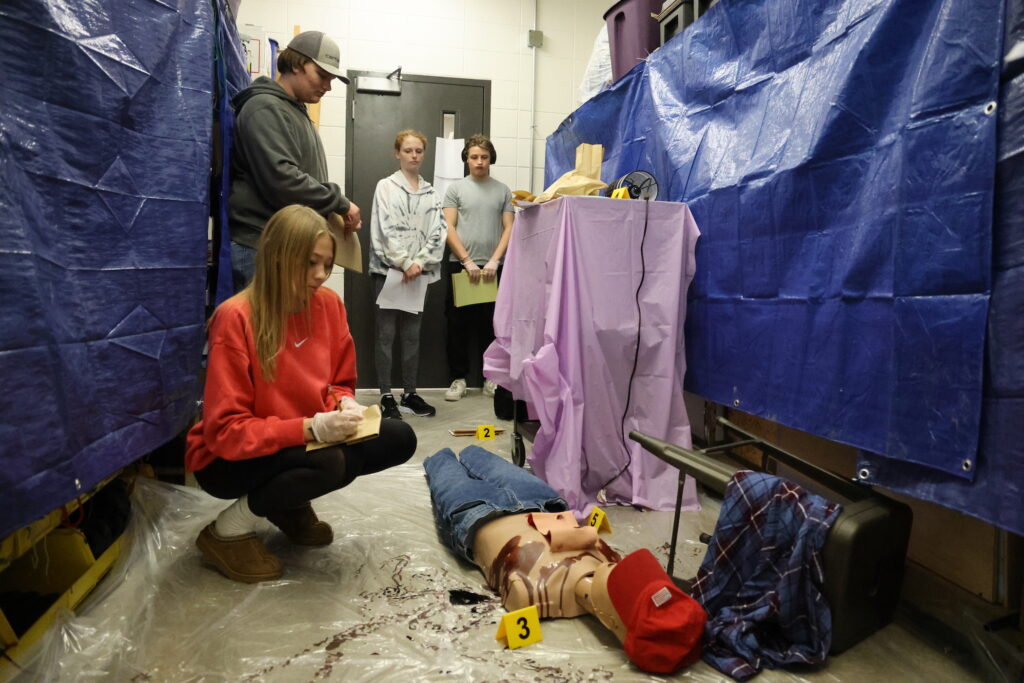 Students investigate a mock crime scene