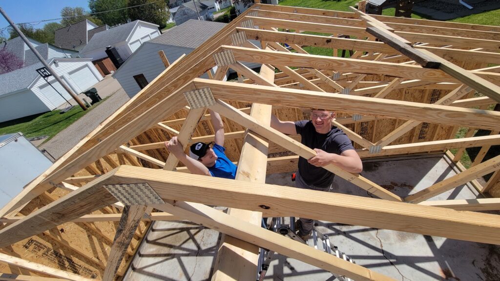 Students in Kyle Krieger’s Construction Trades class work on a three-car garage for an area resident. They started the project this past spring and completed it Nov. 1. 