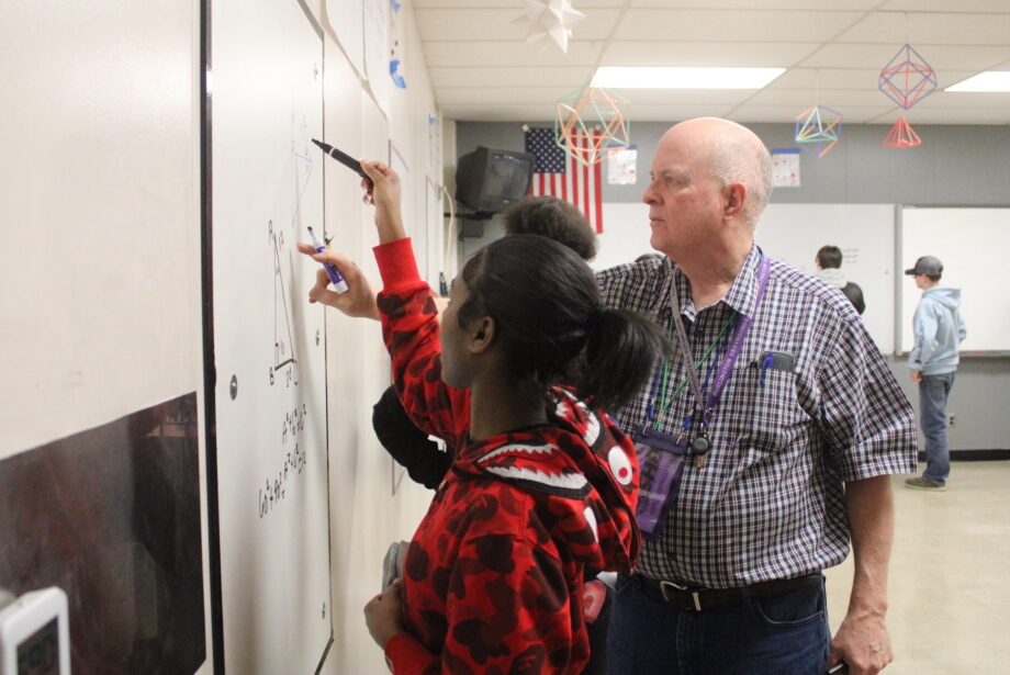 Mark Vasicek reviews work done by a group of students Monday, March 6, 2023, inside his Thinking Classroom at Burlington High School.