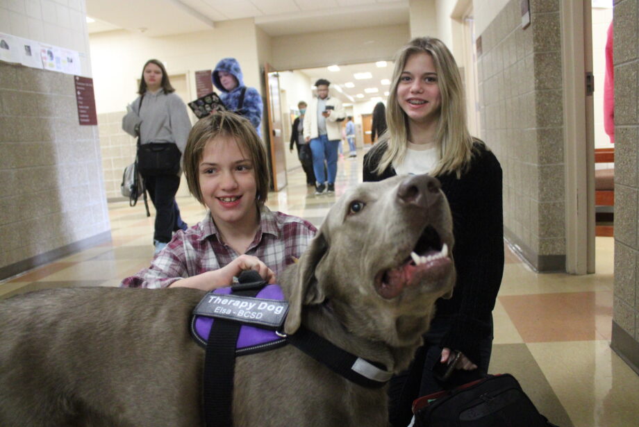 Elizabeth Dickinson and Sophia Kerr greet Elsa Monday, March 20, 2023, at Edward Stone Middle School. Elsa is among six either certified or in training therapy dogs in the Burlington Community School District.