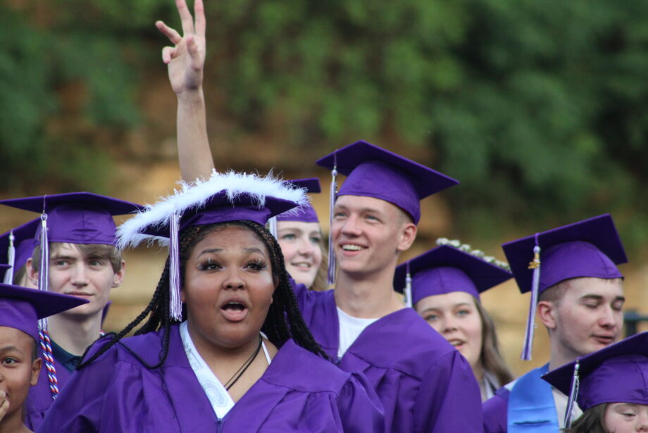 Members of the Burlington High School Class of 2023 wave to family and friends sitting in the stands Saturday, June 3, 2023, during their commencement ceremony at Bracewell Stadium.