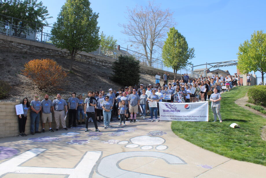 Students, staff and community members gather Friday, April 28,2023, at Bracewell Stadium before walking to the Port of Burlington for the second annual Burlington Community Walk to Fight Suicide.