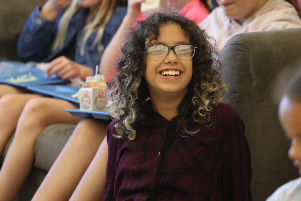 Sixth-grader Charlotte Marlett smiles during Girls Group Sept. 17, 2024, at Aldo Leopold Intermediate School. Girls Group takes place twice a week during the lunch hour. 