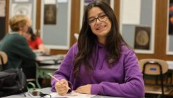 Sarra Yahyaoui, 16, smiles for a photo while drawing during her 2-D Art class in Anthony Onesto’s classroom at Burlington High School. Yahyaoui is one of six foreign exchange students studying at BHS this year. A math major back home, this is her first time taking an art class.