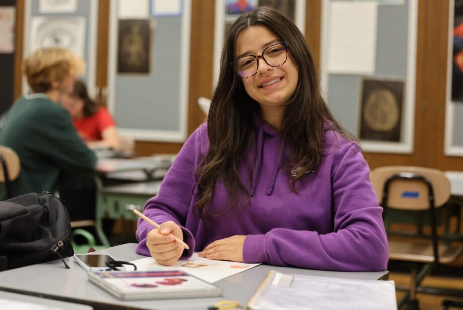 Sarra Yahyaoui, 16, smiles for a photo while drawing during her 2-D Art class in Anthony Onesto’s classroom at Burlington High School. Yahyaoui is one of six foreign exchange students studying at BHS this year. A math major back home, this is her first time taking an art class.