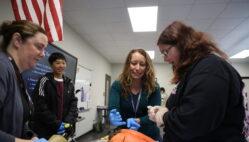 Health occupations teacher Mary Zippe and Deanna Johannsen, an associate professor and clinical coordinator of respiratory care for Southeastern Community College, show students the differences between healthy and diseased lungs April 19, 2024, in the newly renovated health science wing of Burlington High School.