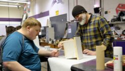 Burlington High School senior Josh Heitmeier and Industrial Technology teacher Aaron Garr paint a birdhouse Friday, Feb. 21, 2025, in the IT classroom at BHS. Heitmeier was among several students enjoying the school’s inaugural Adaptive Industrial Technology class during the second trimester.