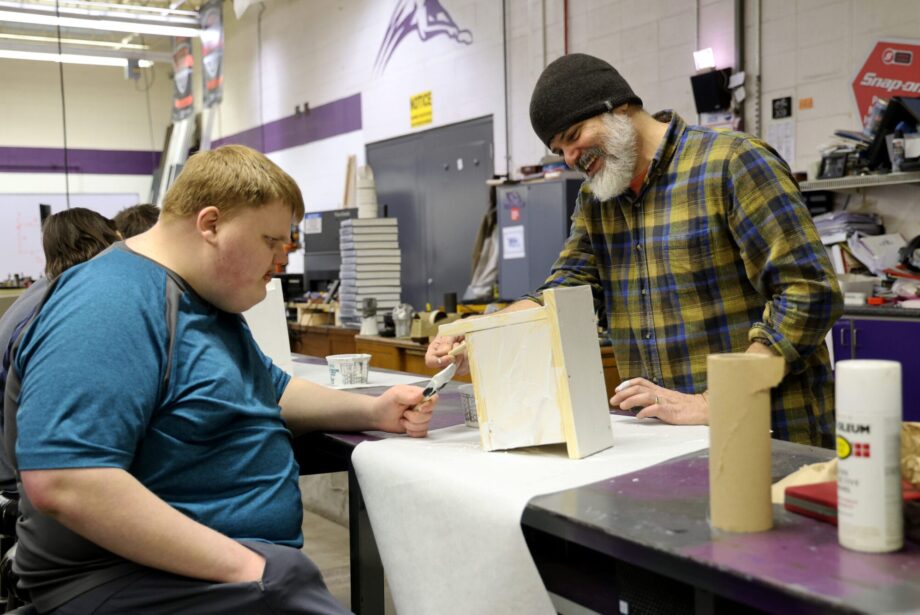 Burlington High School senior Josh Heitmeier and Industrial Technology teacher Aaron Garr paint a birdhouse Friday, Feb. 21, 2025, in the IT classroom at BHS. Heitmeier was among several students enjoying the school’s inaugural Adaptive Industrial Technology class during the second trimester.