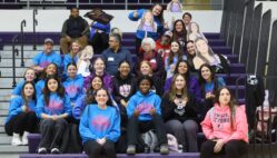 The girls wrestling team and their parents and coaches pose for a photo Feb. 5 ahead of a send-off assembly. Six girls wrestlers qualified for state: Alannah Peterson (5th place), Amaziah Twillie (6th place), Macy Peterson (6th place), Kiara Rodriguez (8th place), Mia Oddo and Grace Navarre.