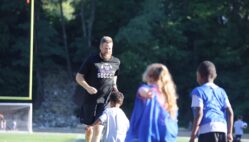 Trevor Cushman is chased by children during a soccer drill June 26, 2024, during Grayhound Soccer Camp at Bracewell Stadium. Trevor, a 2004 graduate of Burlington High School, is carrying on his father’s legacy as the new head coach of the Burlington High School boys soccer team.