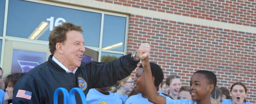 Jake Steinfield and a student high five during the ribbon cutting for the DON'T QUIT Fitness Center.