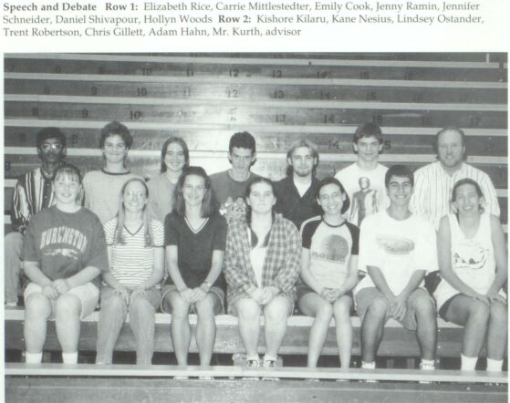 A yearbook photo shows Dale Kurth alongside his first ever Speech and Debate team: Elizabeth Rice, Carrie Mittlestedter, Emily Cook, Jenny Ramen, Jennifer Schneider, Daniel Shivapour, Hollyn Woods, Kishore Kilaru, Kane Nisius, Lindsey Ostander, Trent Robertson, Christ Gillett and Adam Hahn.