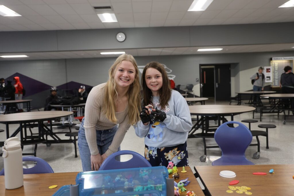 Burlington High School junior Rayleigh Peterson and fourth-grader Lauren Johnson pose for a photo Jan. 15, 2025, in the cafeteria at BHS. “I love being a mentor just to be able to see Lauren every week and I love connecting with her. She’s really fun,” Peterson said. 