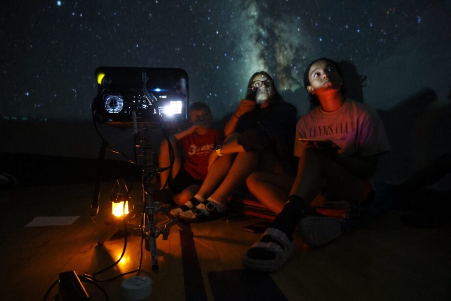 Summer school helpers Kingsley Miller and Kiara Winski operate the star lab July 7, 2024, in the gymnasium at North Hill Elementary School. The two are among 11 high schoolers who worked alongside teachers to make small group and other learning opportunities possible for students enrolled in the summer school program this year.