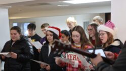 Burlington High School Student Council members sing carols Dec. 15, 2024, at RidgeView Assisted Living. It was among several carolling stops the students made in their quest to spread holiday cheer. The students also presented residents with hand-made holiday cards.