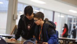 Burlington High School senior Sophie To and her mentee, third-grader Isaiah Rojas, play a “Star Wars”-themed game of Eye Found It Jan. 15, 2025, in the cafeteria at BHS. The duo are among 34 mentor/mentee pairs this year in Club M, which over its past 10 years has served 734 students.