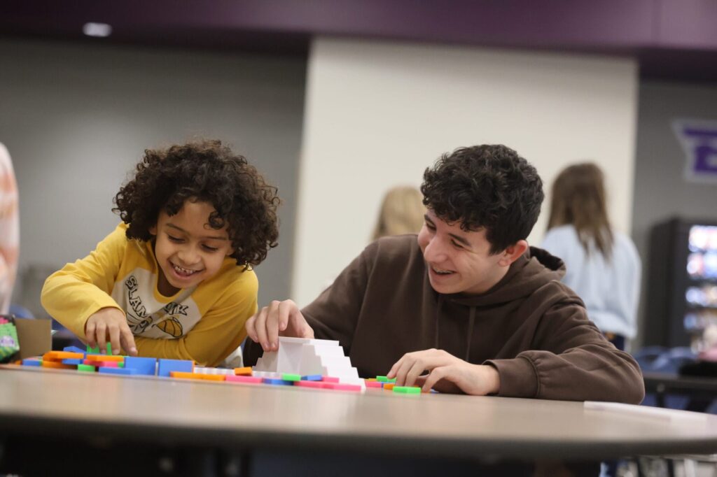 Burlington High School sophomore Owen James and his mentee, first-grader Roman Boyce, play with blocks Jan. 15, 2025, in the cafeteria at BHS. “(The mentees) bring a bunch of energy and they just brighten your day,” James said. 