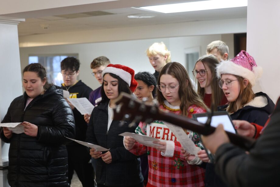 Burlington High School Student Council members sing carols Dec. 15, 2024, at RidgeView Assisted Living. It was among several carolling stops the students made in their quest to spread holiday cheer. The students also presented residents with hand-made holiday cards.